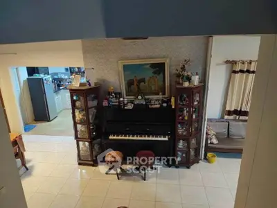 Charming living room with piano and elegant decor, perfect for music lovers and cozy gatherings.