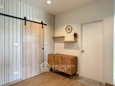 Modern interior with wooden sliding door and stylish cabinet in cozy living space.