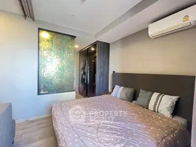 Modern bedroom with stylish decor and air conditioning in a cozy apartment.