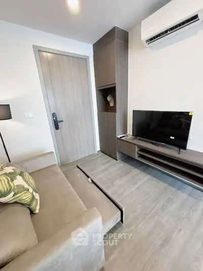 Modern living room with sleek furniture and air conditioning, perfect for comfortable living.