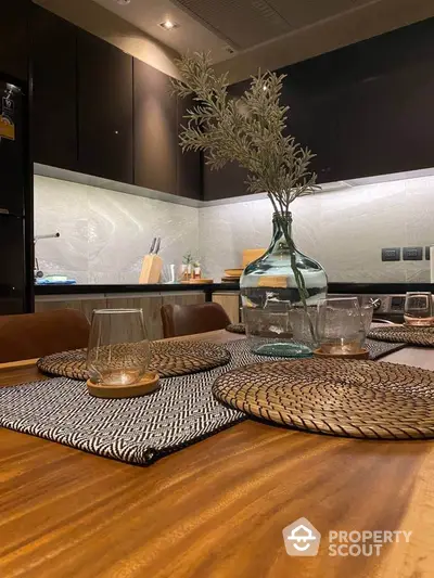 Modern kitchen with elegant decor and sleek cabinetry, featuring a stylish dining setup.