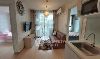 Modern living room with chic decor and open kitchen layout in a stylish apartment.