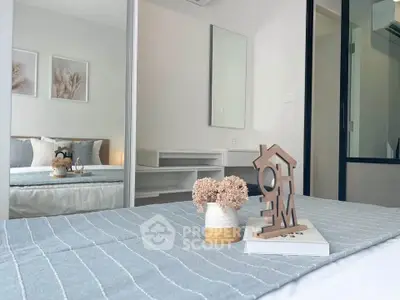 Modern bedroom with stylish decor and cozy ambiance, featuring a large mirror and elegant furnishings.