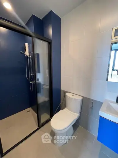 Modern bathroom with sleek shower and blue accents