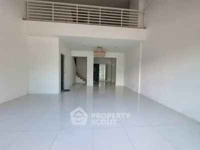 Spacious modern living room with high ceiling and mezzanine level