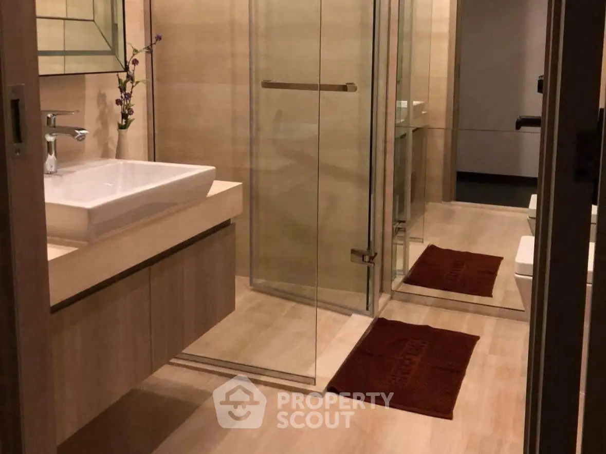 Elegant modern bathroom with glass shower and stylish sink