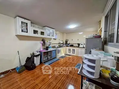 Spacious kitchen with modern appliances and ample storage space.