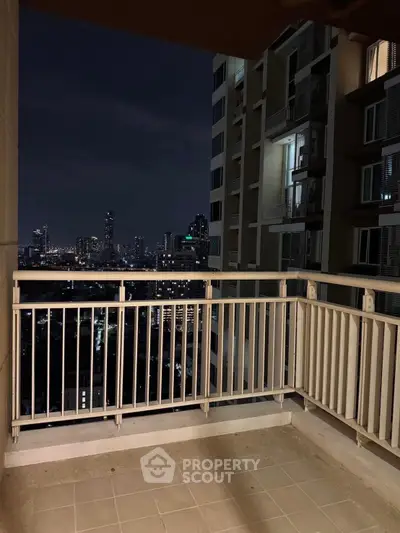Spacious balcony with stunning city skyline view at night