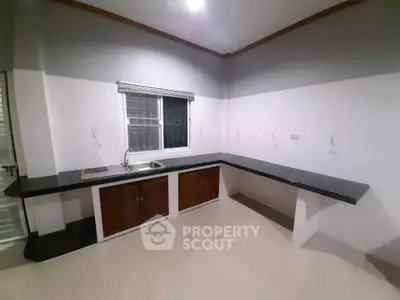 Modern kitchen with sleek black countertops and ample storage space
