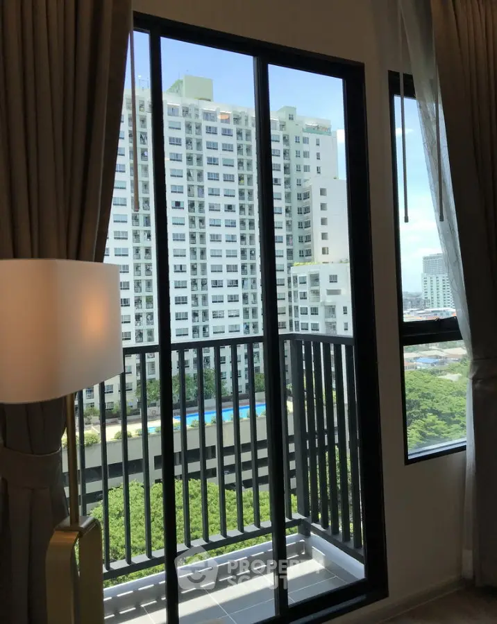 Modern apartment balcony with stunning city view and lush greenery