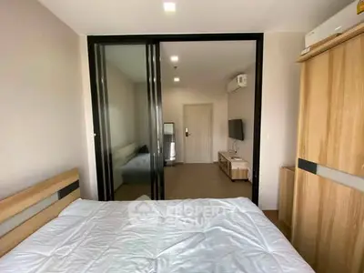 Modern bedroom with sliding glass doors and minimalist decor