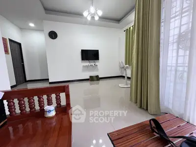 Spacious living room with modern decor and wall-mounted TV