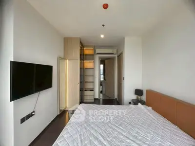 Modern bedroom with wall-mounted TV and stylish wardrobe