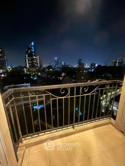 Stunning city skyline view from a cozy balcony at night