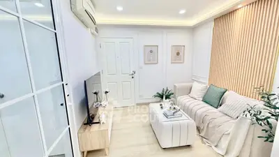 Chic modern living room with cozy seating and stylish decor, perfect for relaxation and entertainment.