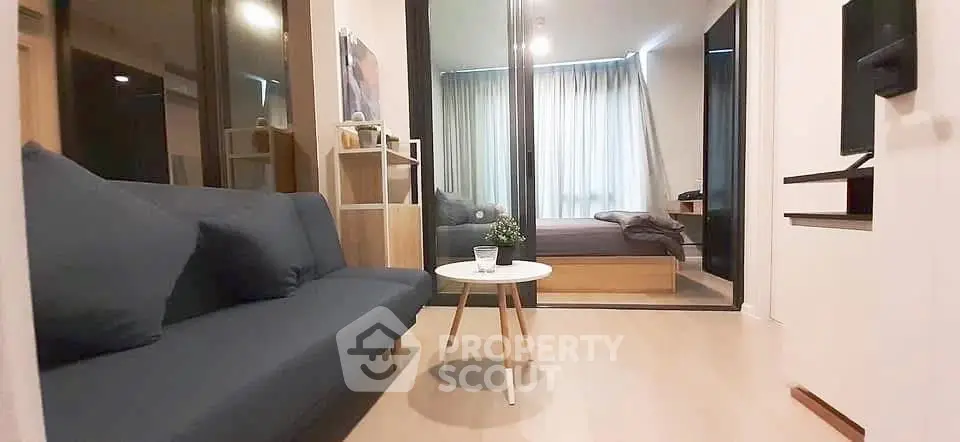 Modern apartment interior with cozy living room and bedroom, featuring stylish furniture and natural light.