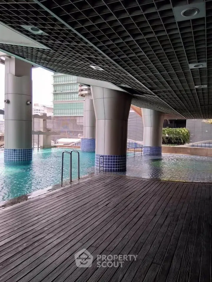 Modern urban pool area with sleek architectural design and city views.