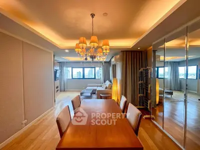 Spacious dining and living area with elegant lighting and city views