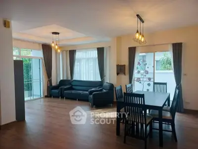 Spacious living room with modern decor and large windows for natural light.