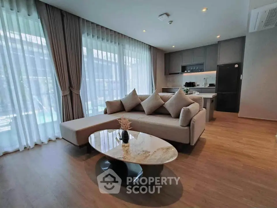 Modern living room with elegant sofa and open kitchen design