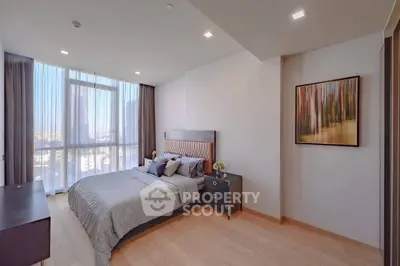 Spacious modern bedroom with large window and elegant decor in a luxury apartment.
