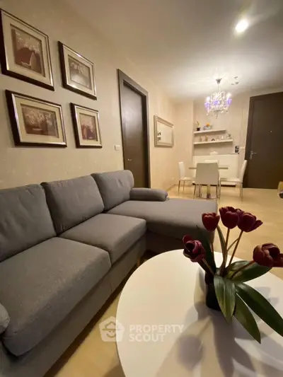 Stylish living room with modern gray sofa and elegant dining area, perfect for cozy gatherings.