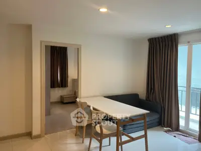 Modern apartment interior with dining area and balcony view
