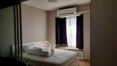 Cozy bedroom with air conditioning and natural light, perfect for relaxation.