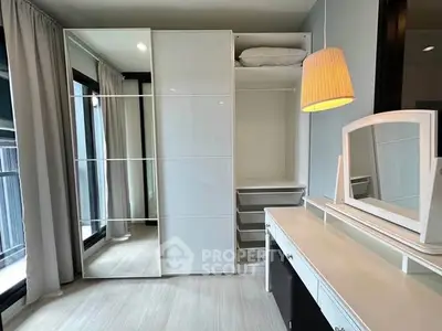 Modern bedroom with sleek wardrobe and stylish vanity in bright natural light.