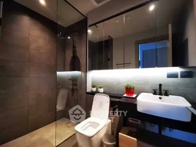 Modern bathroom with sleek design, glass shower, and stylish fixtures.