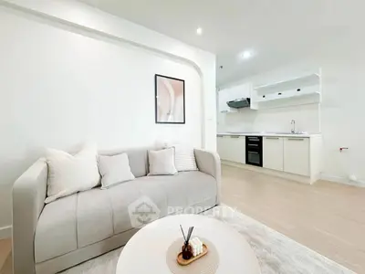 Modern living room with cozy sofa and sleek kitchen in open layout apartment