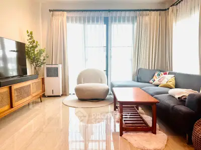 Bright and cozy living room with modern furniture and large windows.