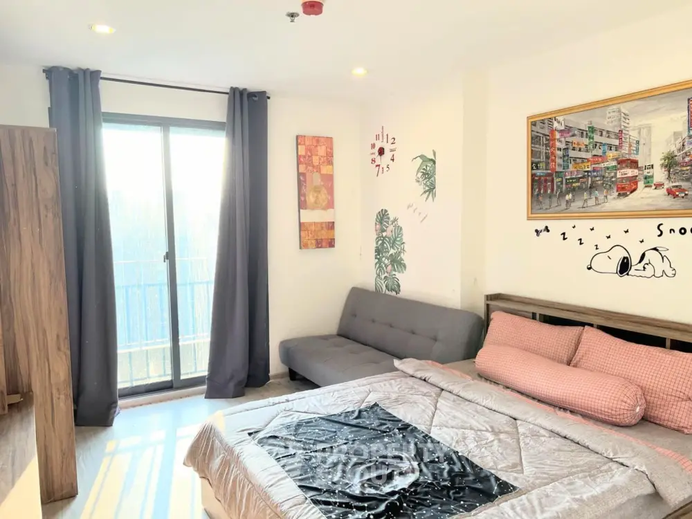 Bright and cozy bedroom with balcony access and stylish decor
