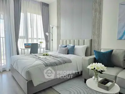 Modern bedroom with elegant decor, featuring a cozy bed, stylish sofa, and natural light from large windows.