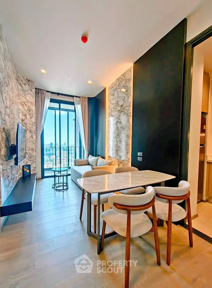 Modern living room with stylish decor and large windows offering a stunning city view.