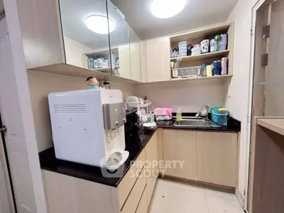 Modern kitchen with sleek cabinetry and appliances, featuring a compact and efficient layout.