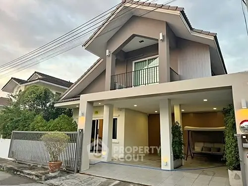 Charming two-story house with modern facade and cozy balcony in suburban neighborhood.