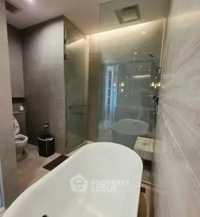 Luxurious modern bathroom with elegant bathtub and glass shower enclosure