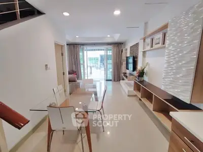 Modern living room with open layout, stylish furniture, and natural light.