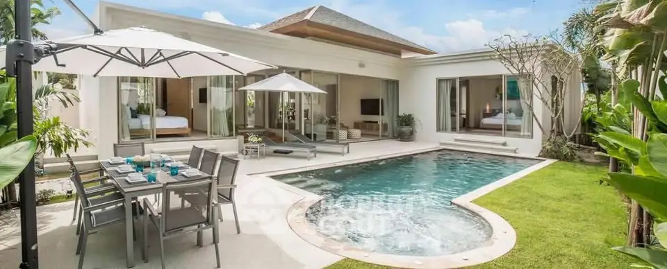 Luxurious villa with private pool, spacious patio, and modern outdoor dining area, perfect for relaxation and entertainment.