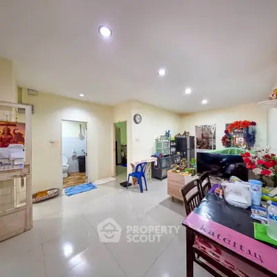 Spacious living area with modern decor and open layout, featuring dining and entertainment spaces.