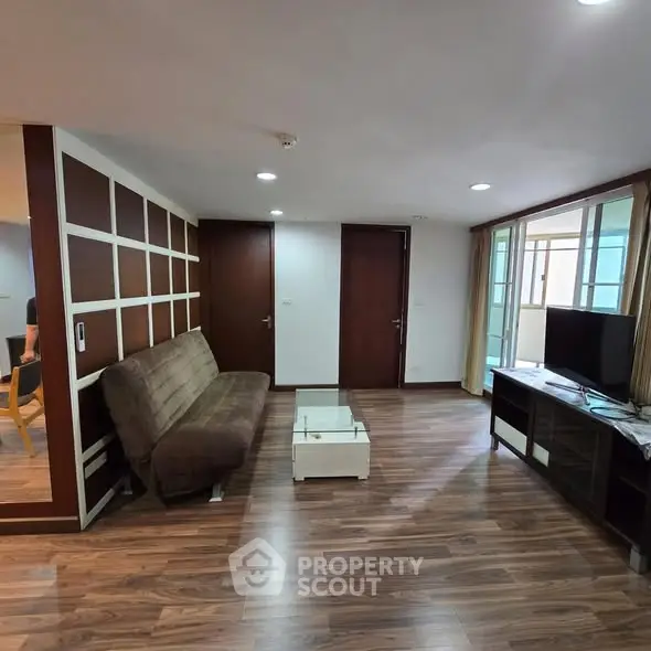 Spacious living room with modern decor and wooden flooring