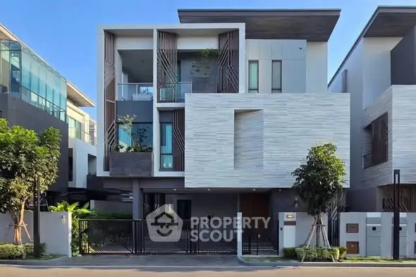 Modern luxury home exterior with sleek architectural design and lush landscaping.
