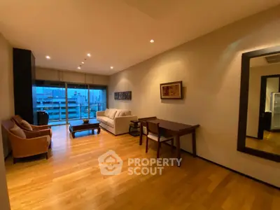 Spacious living room with wooden flooring and city view, perfect for modern urban living.