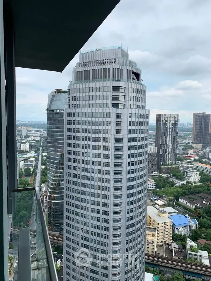 Stunning cityscape view from high-rise balcony showcasing modern skyscrapers and urban landscape.