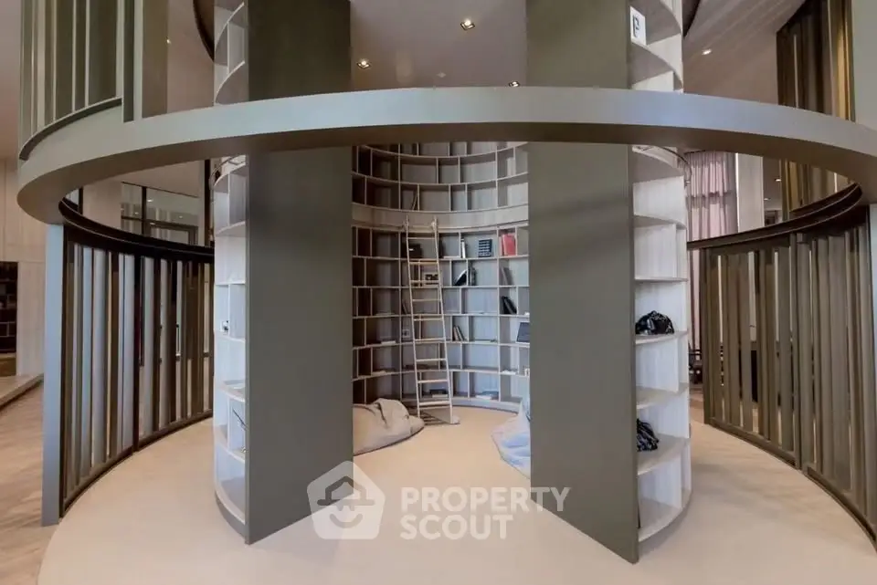 Stunning modern library with circular design and ladder access, perfect for book lovers and elegant interiors.