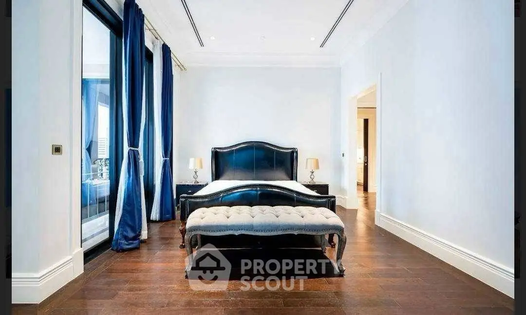 Luxurious bedroom with elegant dark wood flooring and stylish black bed frame.
