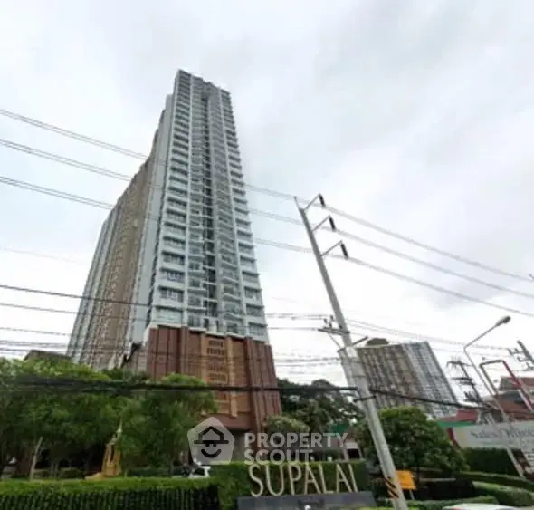Stunning high-rise building with modern architecture and lush greenery at Supalai.