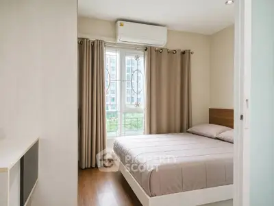 Modern bedroom with large window and air conditioning in a stylish apartment.