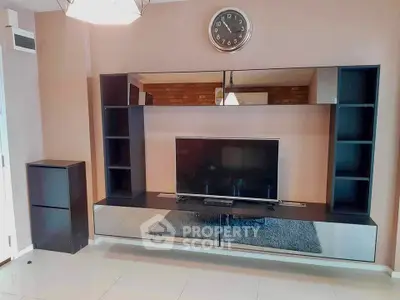 Modern living room with sleek entertainment center and wall clock